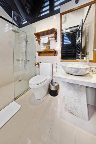 a bathroom with a toilet and a sink and a shower at Joy Villa Sapa in Sapa