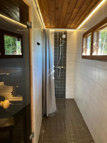 a bathroom with a shower with a shower curtain at Glamping by the sea in Äggrund