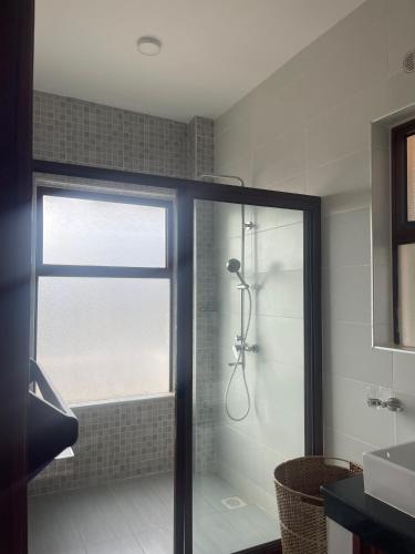 a bathroom with a shower with a glass door at Villa in Vipingo in Vipingo