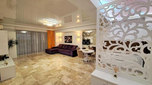 a living room with a couch and a table at KYA Luxury in Mamaia