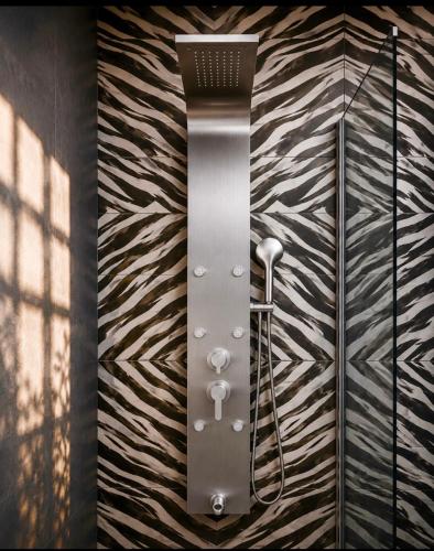 a shower in a bathroom with a wall at RoofTop Boutique Hotel Adults Only in Serekunda