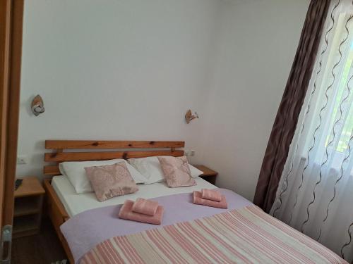 a bedroom with a bed with two towels on it at Apartmani Sorić in Prijeboj