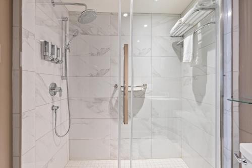 a bathroom with a shower with a glass door at Le Clos Saint-Louis - Par Aneyro in Quebec City