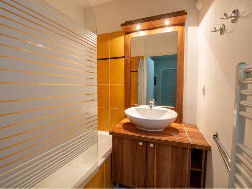 a bathroom with a sink and a mirror at Les Chalets d Ax N212 - 2P6C in Ax-les-Thermes