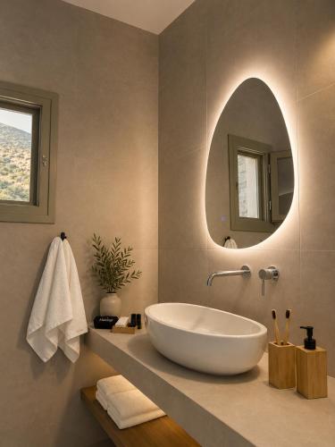 a bathroom with a large white tub and a mirror at Thyme Timeless Stay in Kamares