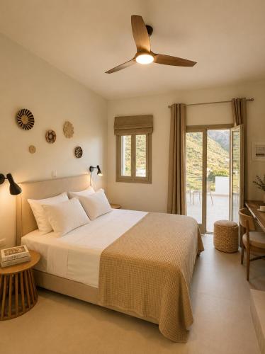 a bedroom with a bed and a ceiling fan at Thyme Timeless Stay in Kamares