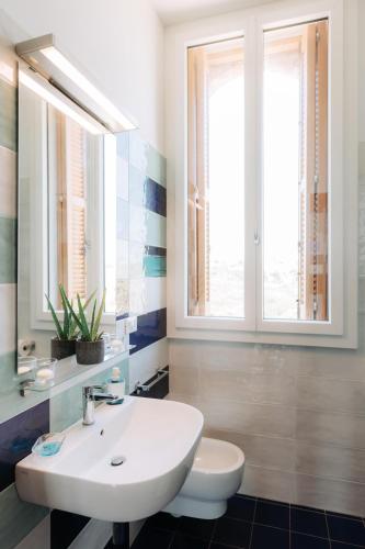 a bathroom with a white sink and a toilet at Villa Incina - Sea House in Polignano a Mare
