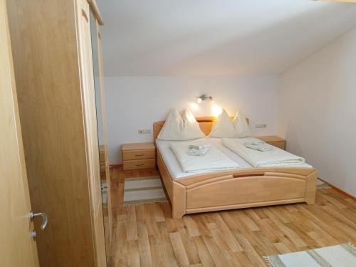 a small bedroom with a bed with a light on it at Stapfgut in Rauris