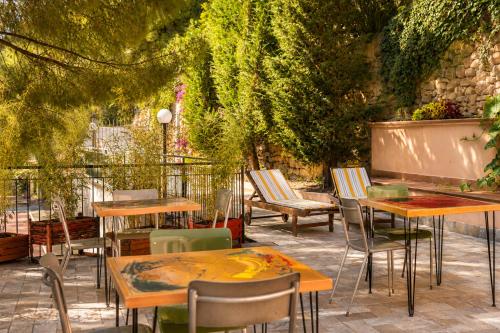 a group of tables and chairs in a patio at Officine Bordighera in Bordighera