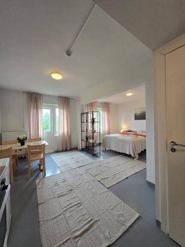 a bedroom with a bed and a table and a desk at Kyyveden Kartano Horsma 14 in Mikkeli