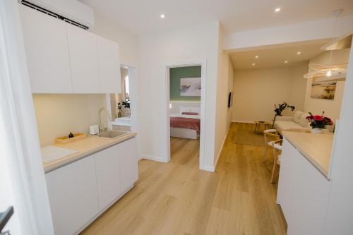 a room with a kitchen and a living room at Camelia's cozy place in Baia Mare