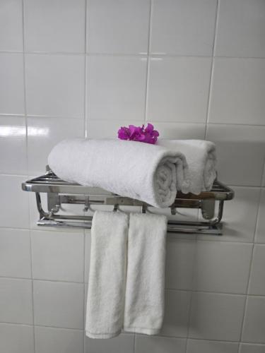 a towel rack with towels on it in a bathroom at Dhiffushi Reef & Beach in Dhiffushi