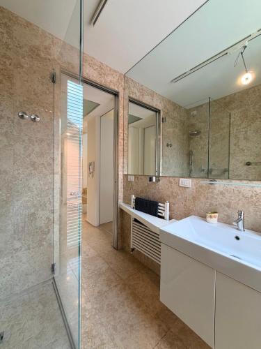 a bathroom with a sink and a glass shower at Villa Celeste -Flexrent Immobiliare Abissinia in Santa Maria di Scacciano