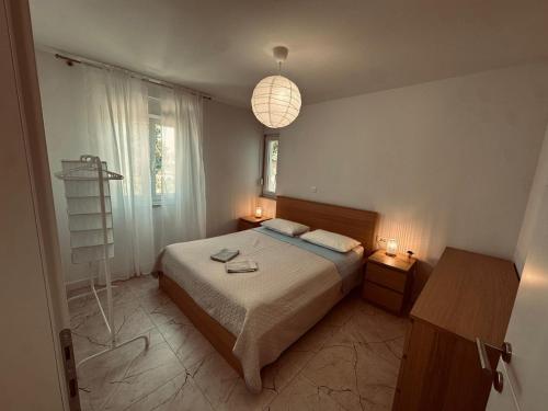 a bedroom with a bed and two night stands and a lamp at Marija in Pakoštane