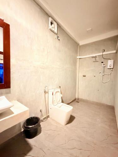 a bathroom with a toilet and a shower at Surf Arugam in Arugam Bay