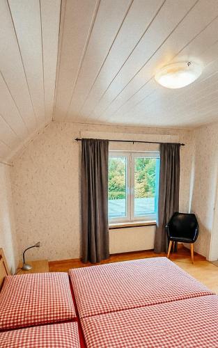 a bedroom with two beds and a window at Übernachten im Café Restaurant Vedder in Herscheid