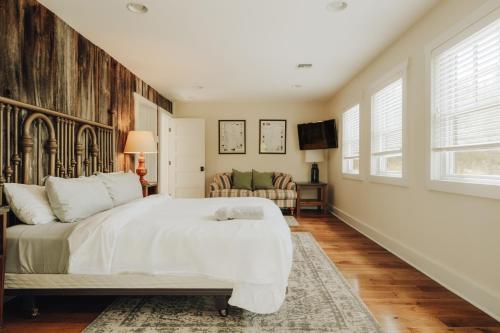 a bedroom with a large bed and a living room at Hot Tub Fire Pit Mountain Retreat Deer Meadows in Jeffersonville