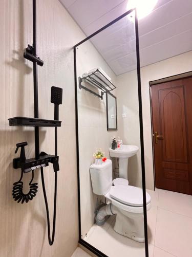 a bathroom with a toilet and a mirror at AL-BUKHARI Boutique Hostel in Bukhara