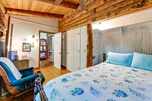 a bedroom with a bed and a wooden wall at Unplug! Lake Toxaway Cabin w/ Dock Access in Lake Toxaway