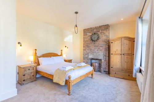 a bedroom with a bed and a fireplace at Spacious Central Harrogate Retreat in Harrogate