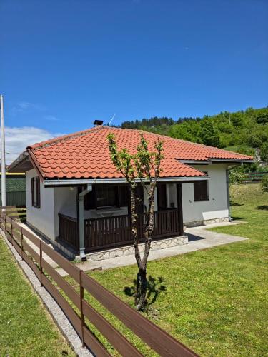 a small tree in front of a house at Apartmani LUX in Kolašin
