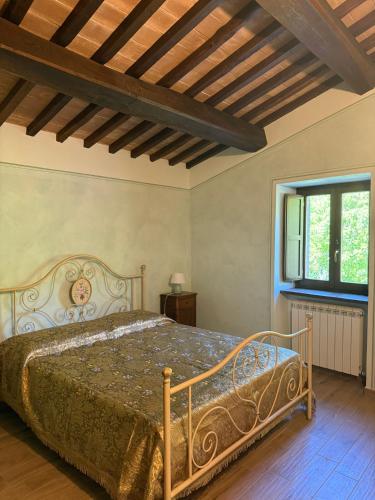 a bedroom with a bed and a window at Castello di Acera in Campello sul Clitunno