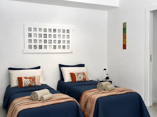 a room with three beds and a calendar on the wall at Malpensa Airport Apartment - 9 min to MXP - Free Parking in Somma Lombardo