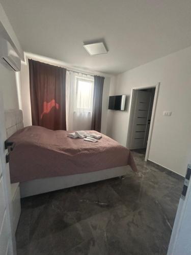 a bedroom with a bed and a window at Villa Maria III in Vodice
