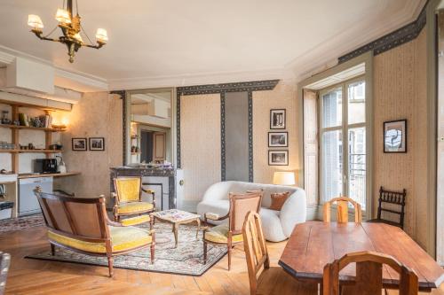 a living room with a couch and a table at Château de Sainte-Sévère in Sainte-Sévère-sur-Indre