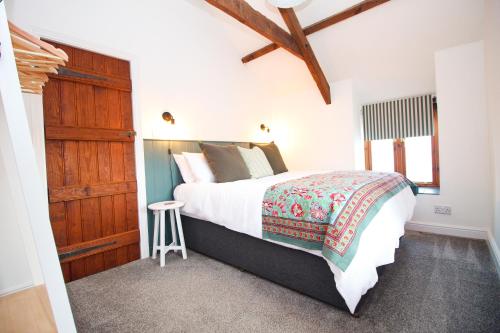 a bedroom with a large bed and a wooden cabinet at Attractive barn conversion near Padstow in Saint Merryn