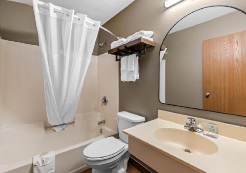 a bathroom with a sink and a toilet and a mirror at Super 8 by Wyndham Perham in Perham