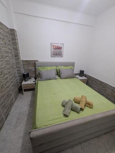 a bedroom with a bed with two towels on it at Angel Room 1 in Nea Plagia