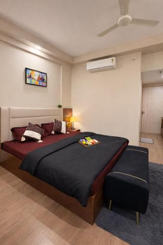 a bedroom with a large bed in a room at Sunbliss Corner in Greater Noida