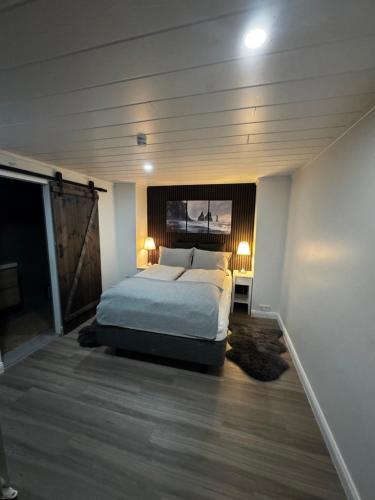 a bedroom with a bed and two lamps in it at Puffin rock in Vestmannaeyjar