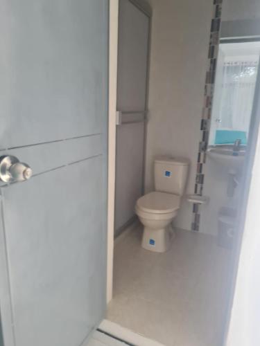 a small bathroom with a toilet in a stall at Huiltana ecohotel&resort in Guataquí