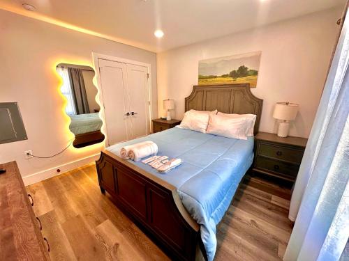 a bedroom with a large bed with a blue blanket at The Chic Suite - 1BR with Luxe Amenities in Paterson
