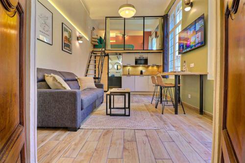 a living room and kitchen with a couch and a table at Duplex Mirabeau - Hyper center city - Calm in Aix-en-Provence