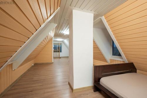 a staircase in a house with wood paneling at Voika majutus in Voika
