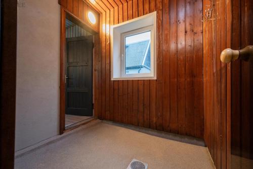 an empty hallway with a window and a door at Voika majutus in Voika