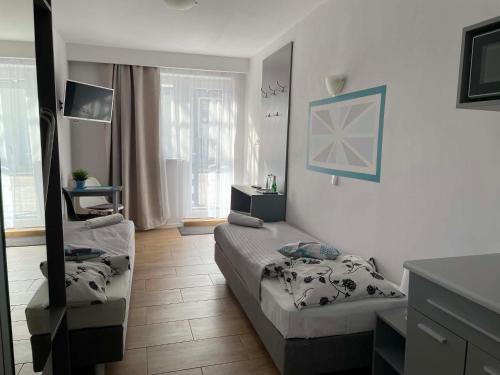 a living room with two beds and a mirror at Marinas Rewa in Rewa