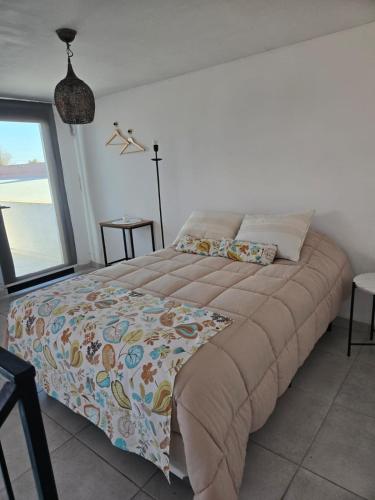 a large bed in a bedroom with a window at Loft Amplio y moderno con parque CASARENT in Carlos Casares