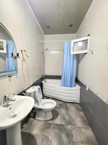 a bathroom with a toilet and a sink and a shower at Дом in Kobuleti