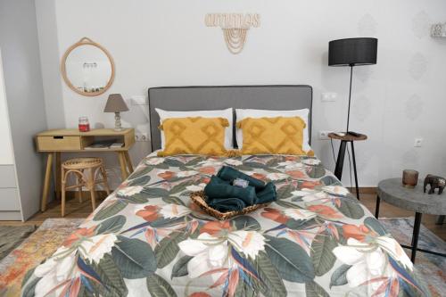 a bedroom with a bed with a colorful comforter at Ammos studio Loutraki in Loutraki
