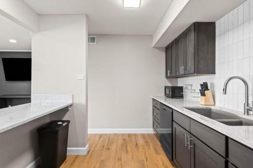 a kitchen with a sink and a counter at Newly Renovated Unit in Central Spfld #303 in Springfield