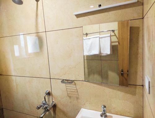 a bathroom with a sink and a mirror at Hotel Royal Stay in Madurai