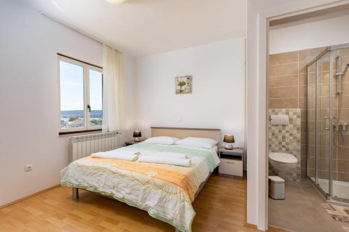 a bedroom with a large bed and a shower at Rooms Vera in Porat