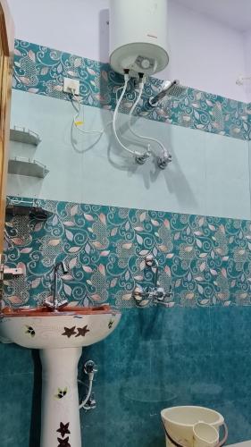 a bathroom with a toilet and a sink at Tungnath View Homestay in Sari