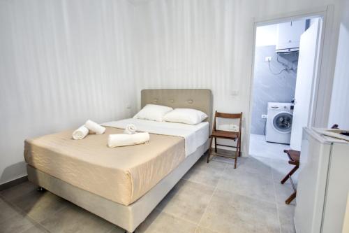 a bedroom with a bed with towels on it at Southern Nights in Gjilek