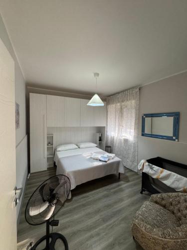 a hotel room with a bed and a chair at Casa C&S in Mascali