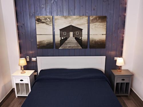 a bedroom with a bed with two tables and two lamps at Beatrice Home in Pompei